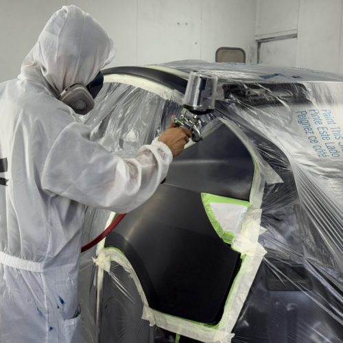 K.W. Auto Body Certified Tesla Repair Technicians K.W. Auto Body Certified Tesla Repair Technician painting vehicle